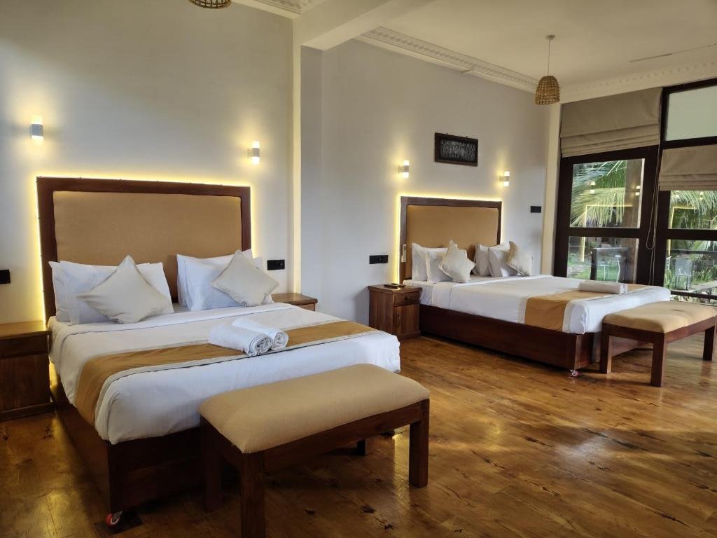 Guest room with two beds and a balcony